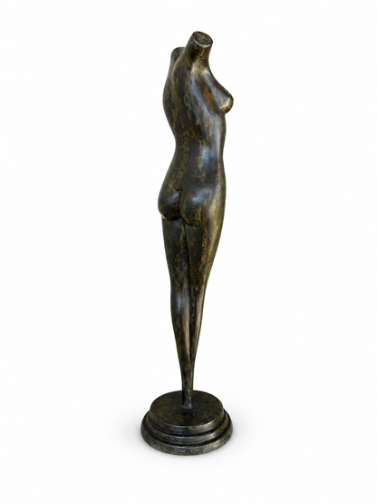 Bronze sculpture of a female figure on a white background, back view.