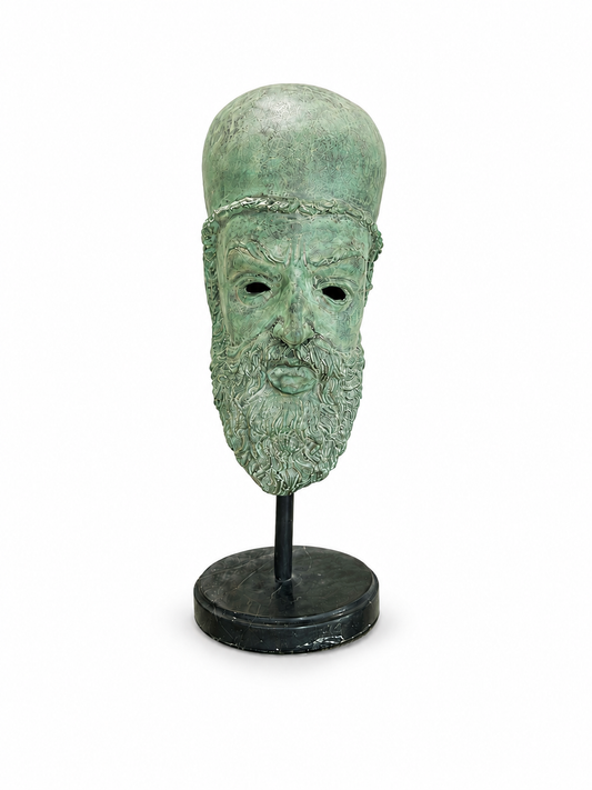 Green bronze mask on a stand and marble bottom against a white background