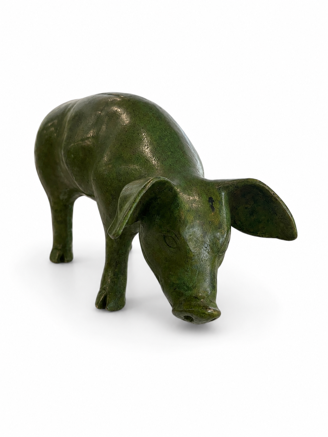 Bronze green pig figurine on a white background. Front view. 