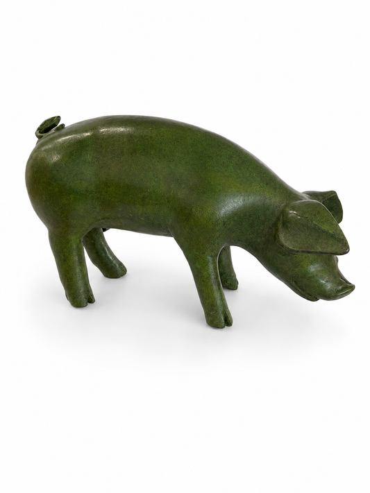 Green pig-shaped object on a white background. Side view.