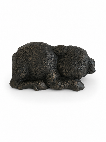 Black pig bronze sculpture on a white background. Back view.