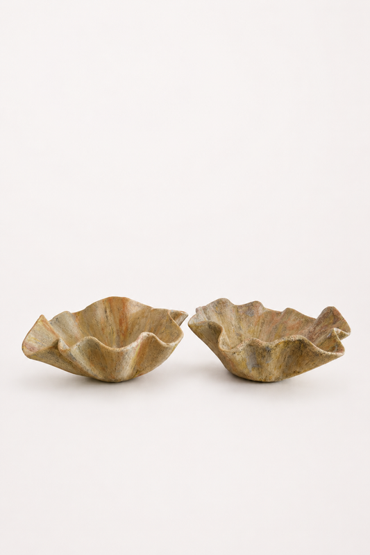 Two sized curved textured ceramic bowls on a white background