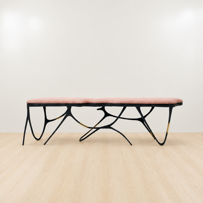 Black brass luxury handmade furniture bench with light pink velvet cushion with modern design, ideal for modern luxury decor, on a white background. Side angle