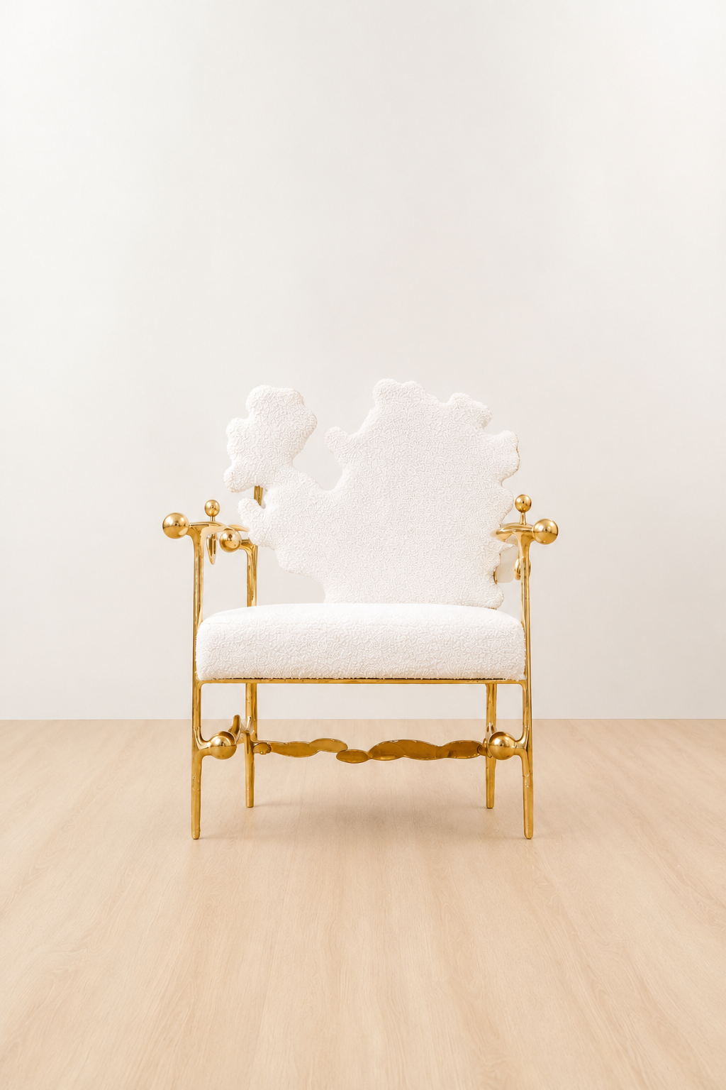 gold brass polished chair with white cushion on a beige floor and light beige wall. straight view.