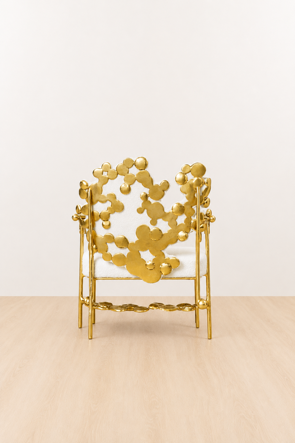 gold brass polished chair with intricate back design on a beige background