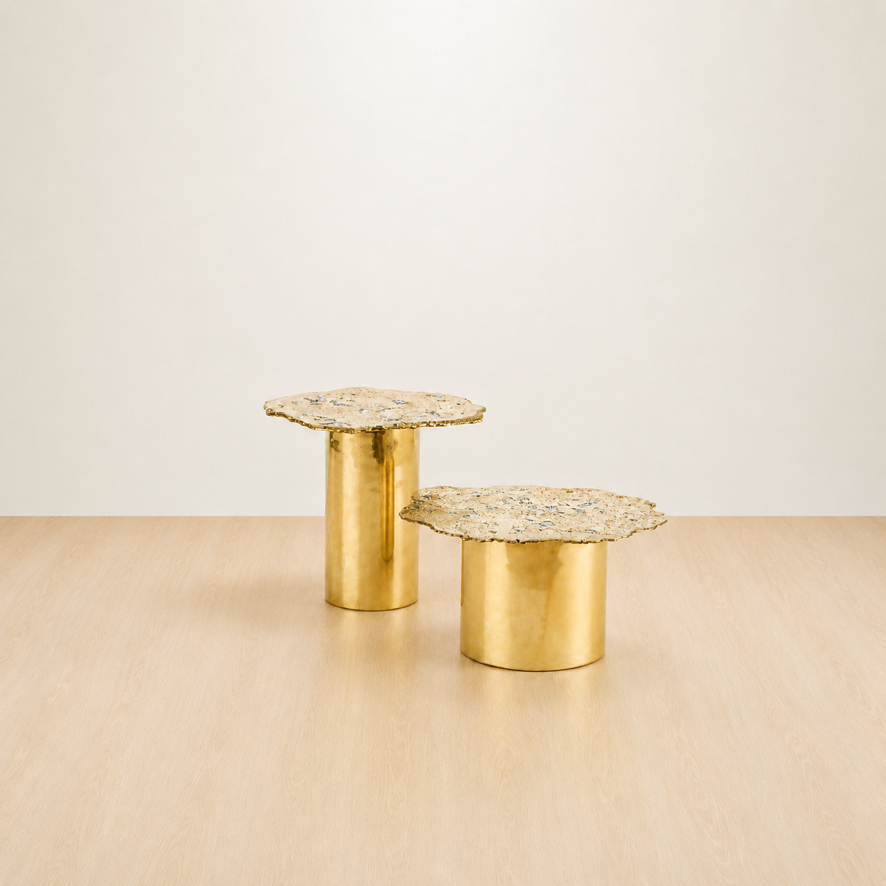 Gold brass accent tables with cylindrical bases and textured organic shaped tops