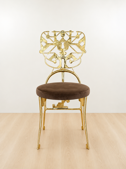 Gold chair with intricate design with brown velvet seat on a white background. Luxury handmade furniture. front angle