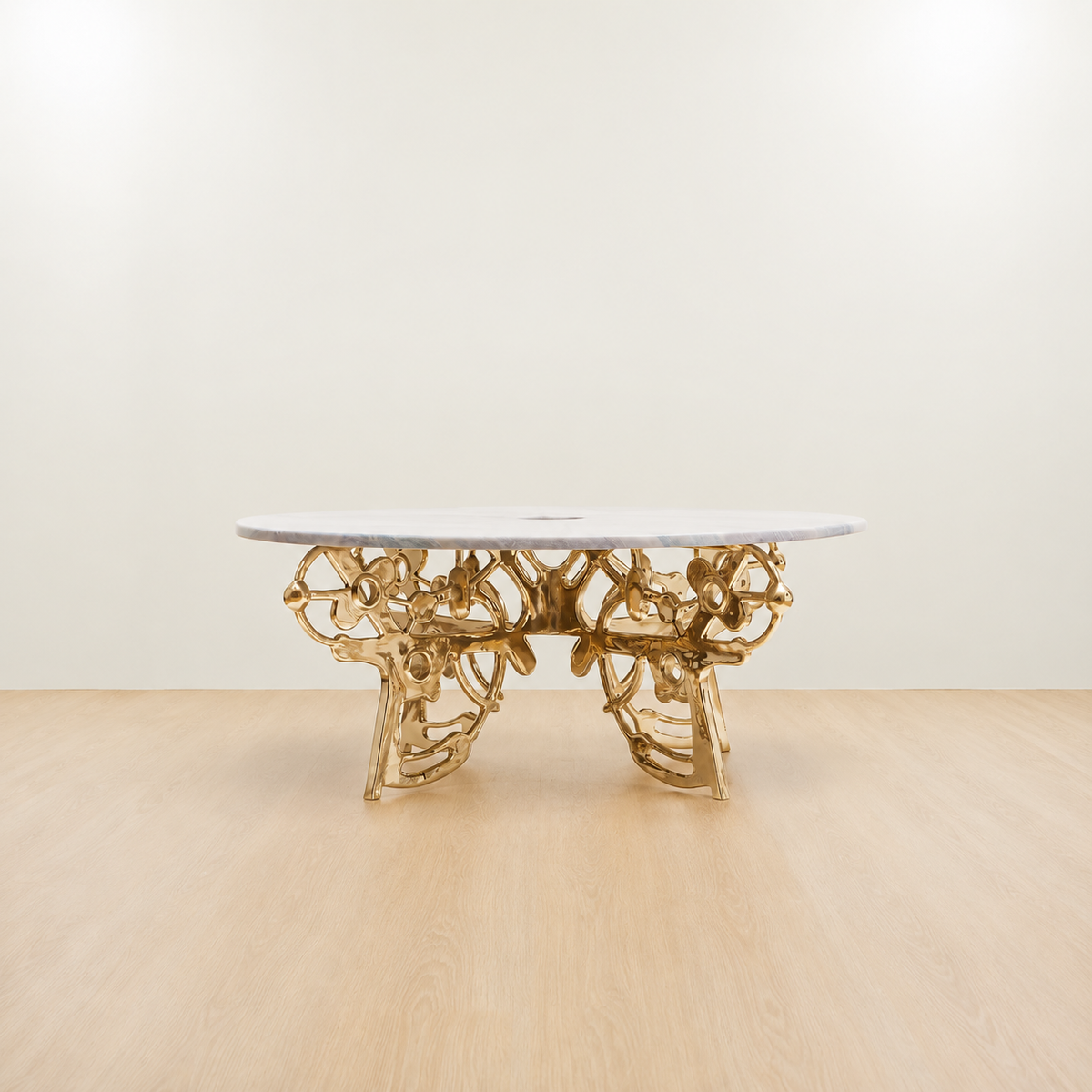 Gold brass coffee table with an organic sculptural base and grey marble top