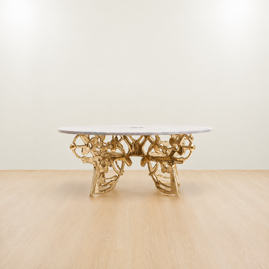Gold brass coffee table with an organic sculptural base and grey marble top