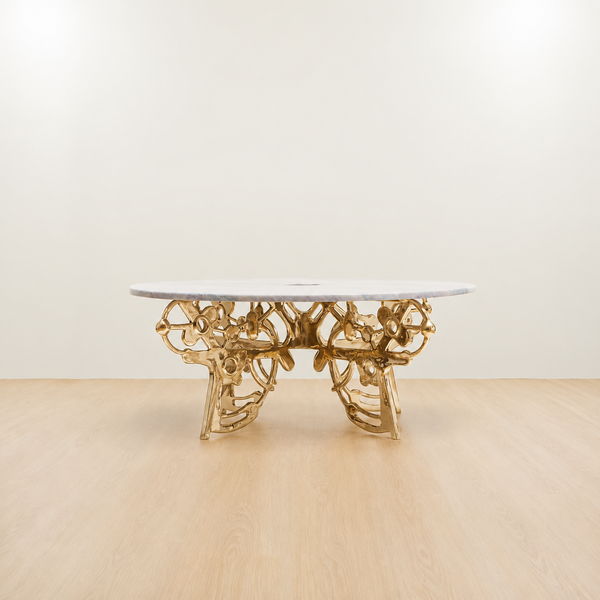 Gold brass coffee table with an organic sculptural base and grey marble top