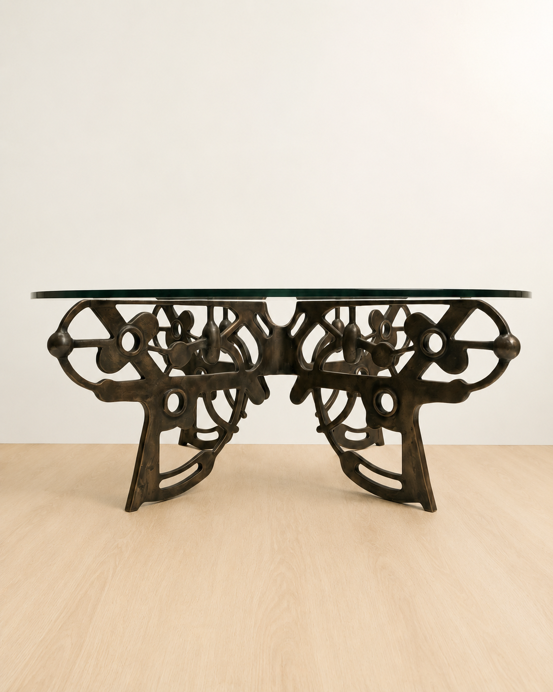 brass coffee table with intricate design with a glass table top