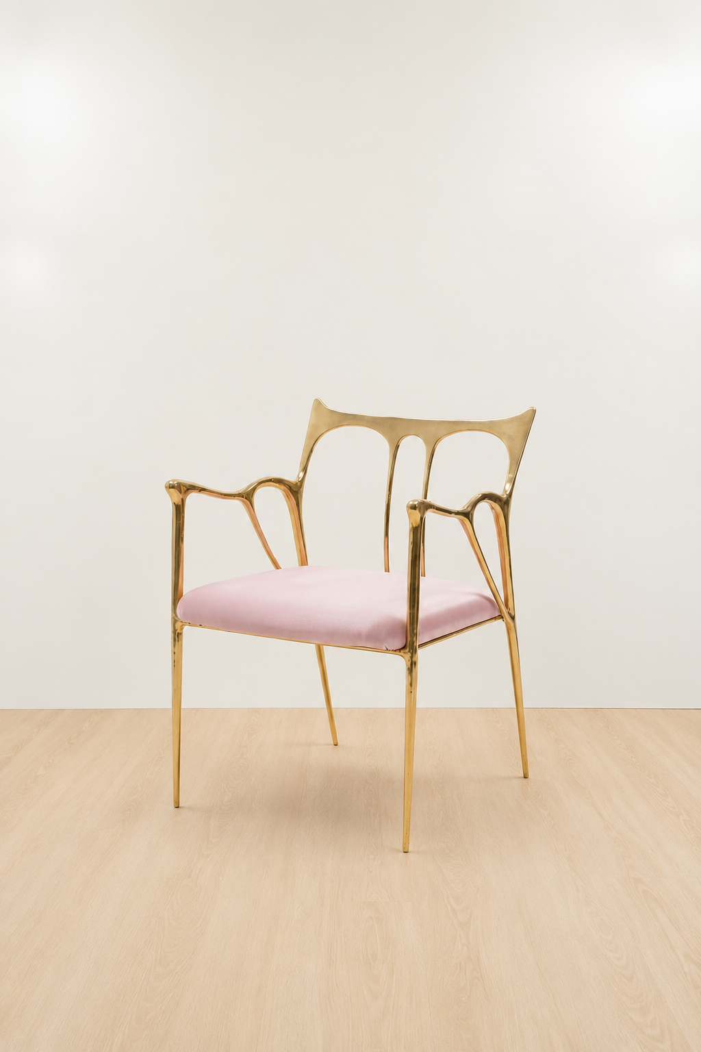 brass Gold chair with a pink cushion on a beige floor and white wall