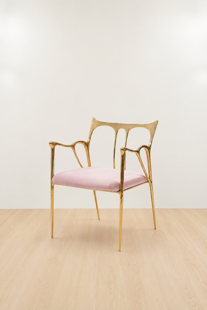 brass Gold chair with a pink cushion on a beige floor and white wall
