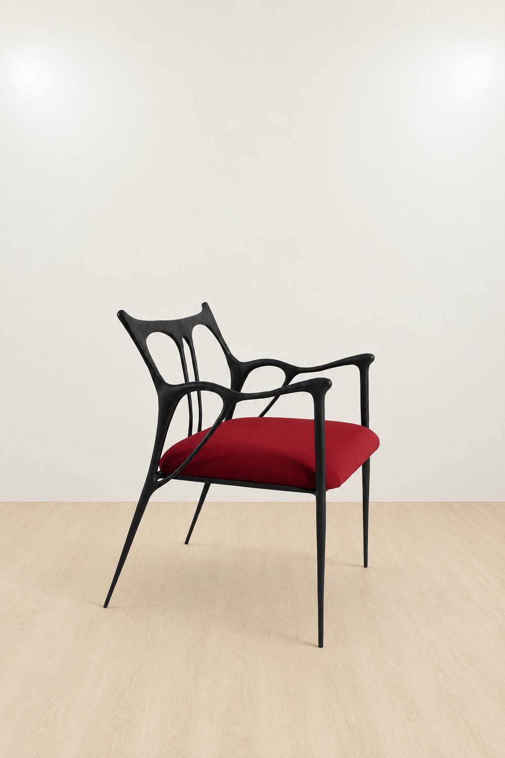 Modern black brass chair with red seat on a beige floor and wall
