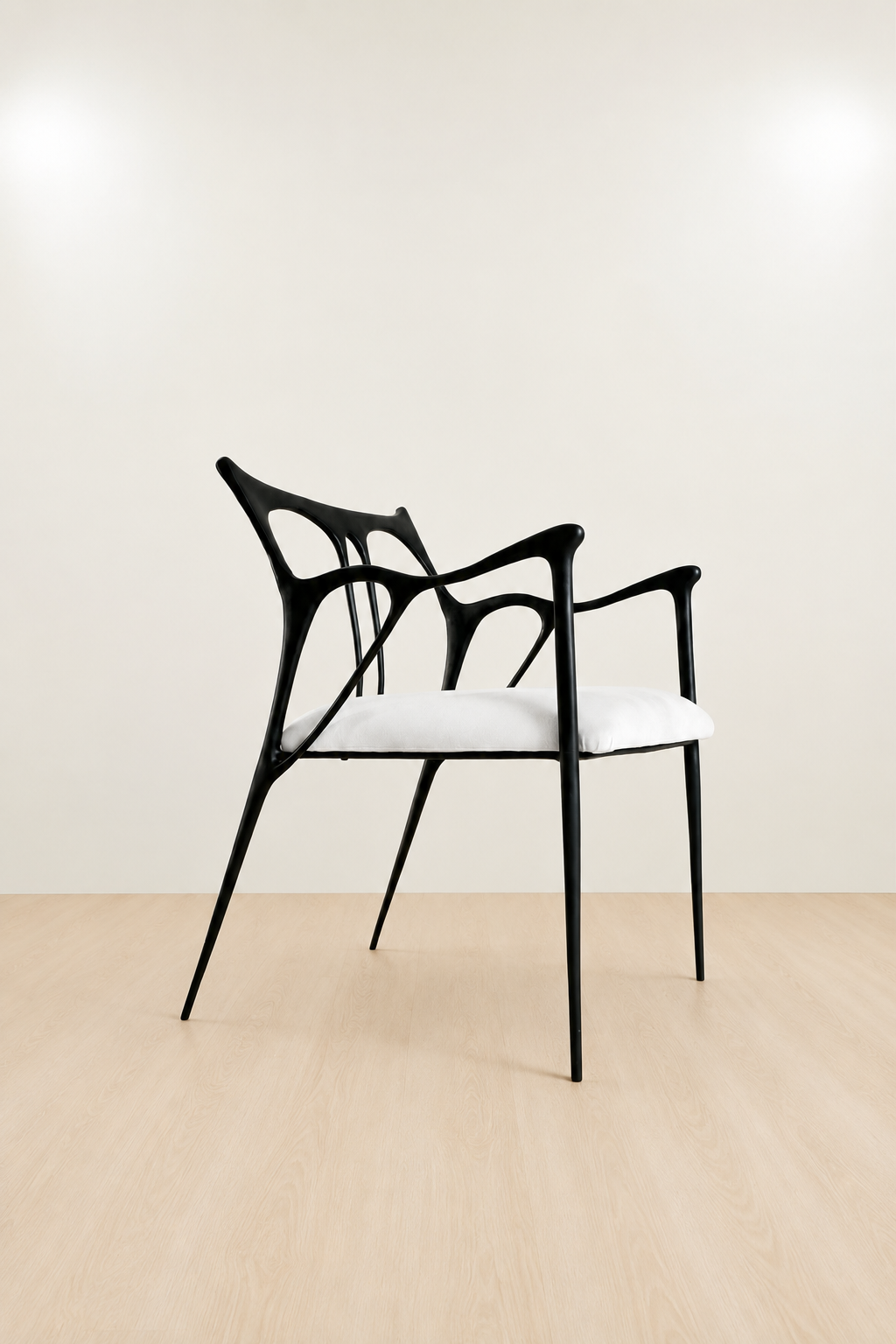 Modern black brass chair with white seat on a beige floor and wall