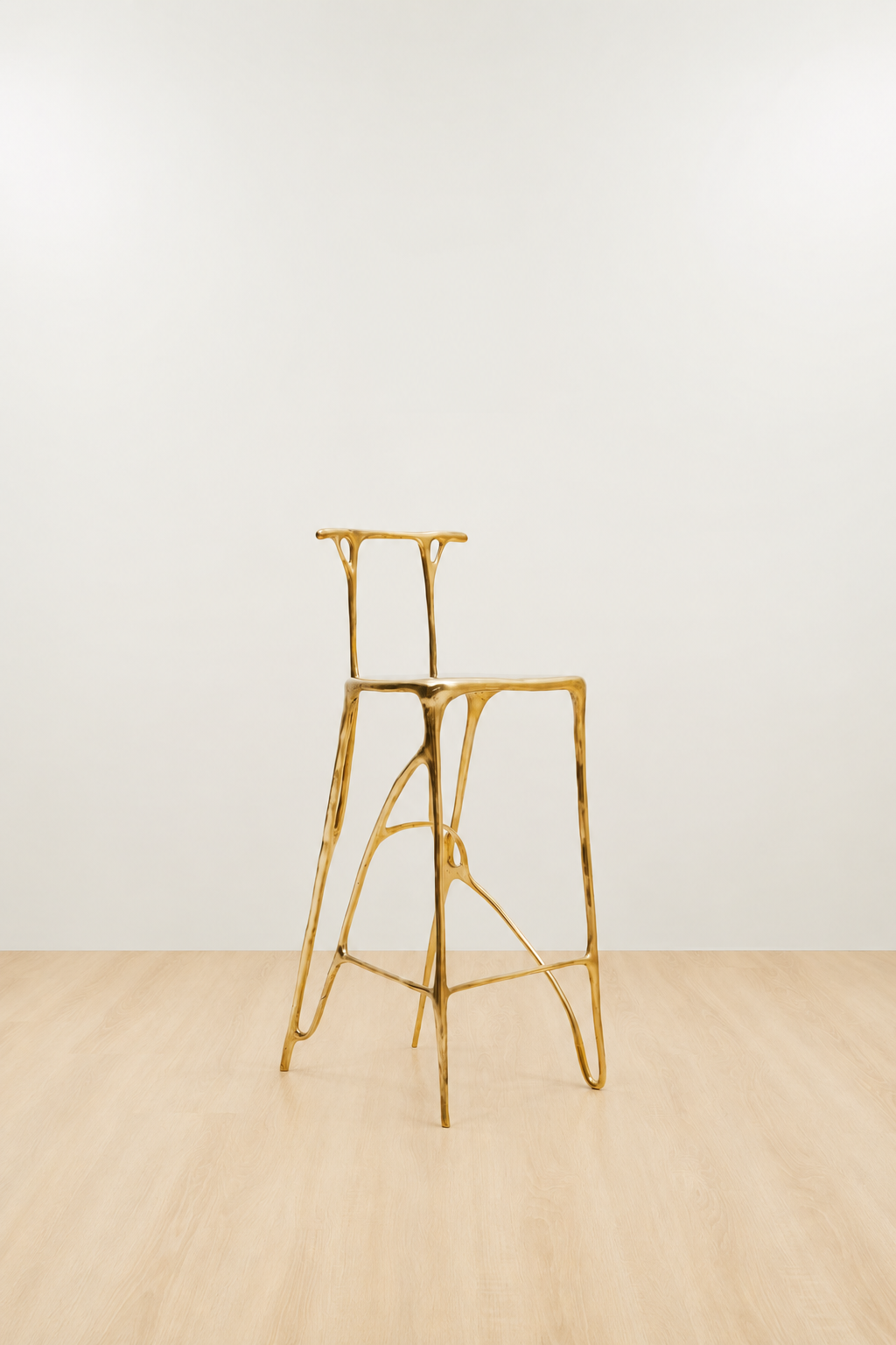 Gold brass bar stool on a white and beige background