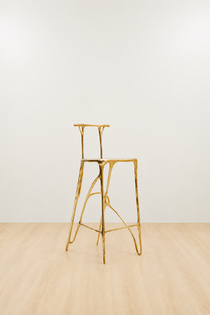 Gold brass bar stool on a white and beige background