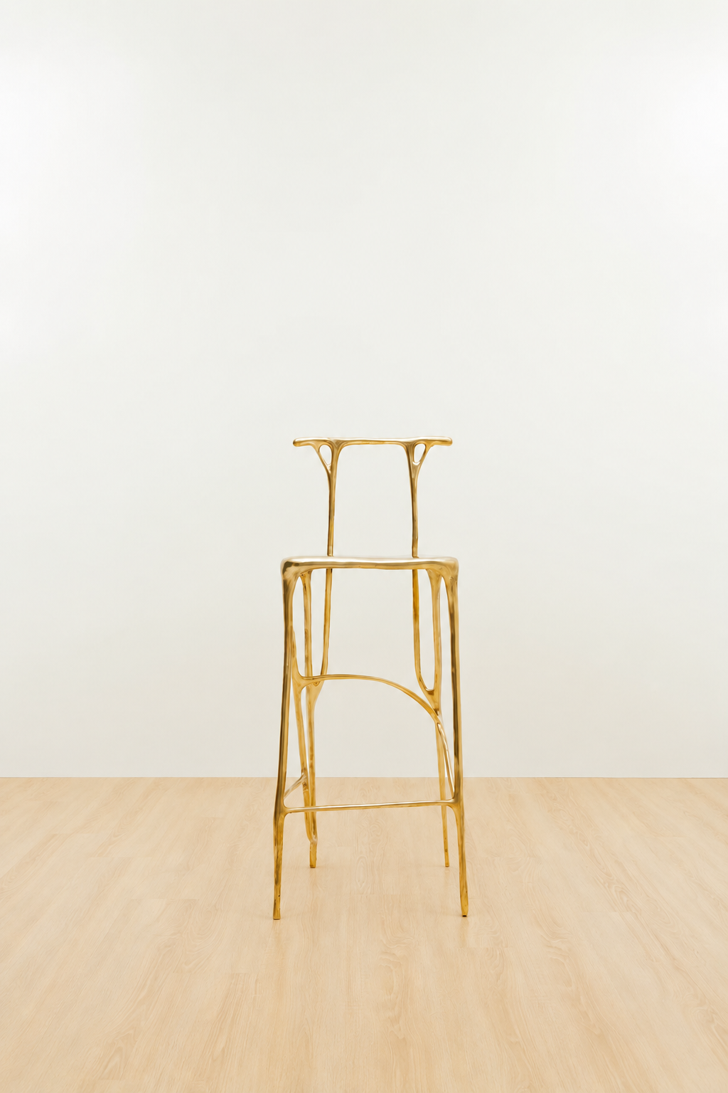 Gold brass bar stool on a white and beige background