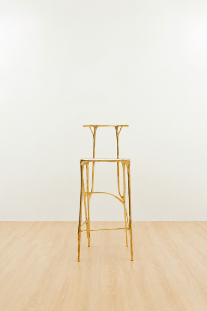 Gold brass bar stool on a white and beige background