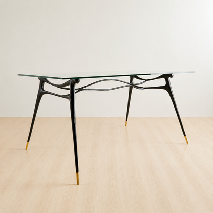 side view of a dining table with Glass table top and black brass base