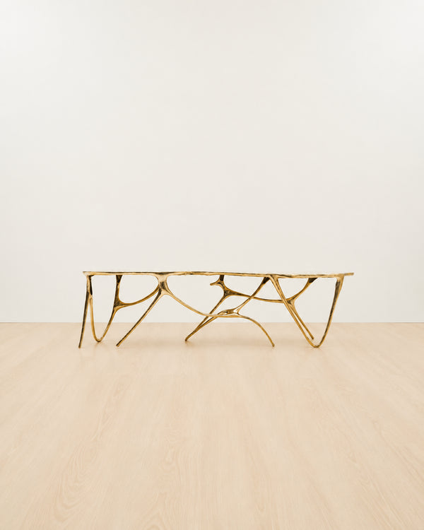 Gold brass luxury handmade furniture bench with modern design, ideal for modern luxury decor, on a white and beige background.