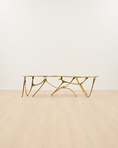 Gold brass luxury handmade furniture bench with modern design, ideal for modern luxury decor, on a white and beige background.