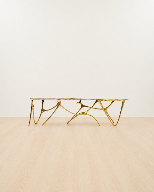 Gold brass luxury handmade furniture bench with modern design, ideal for modern luxury decor, on a white and beige background.