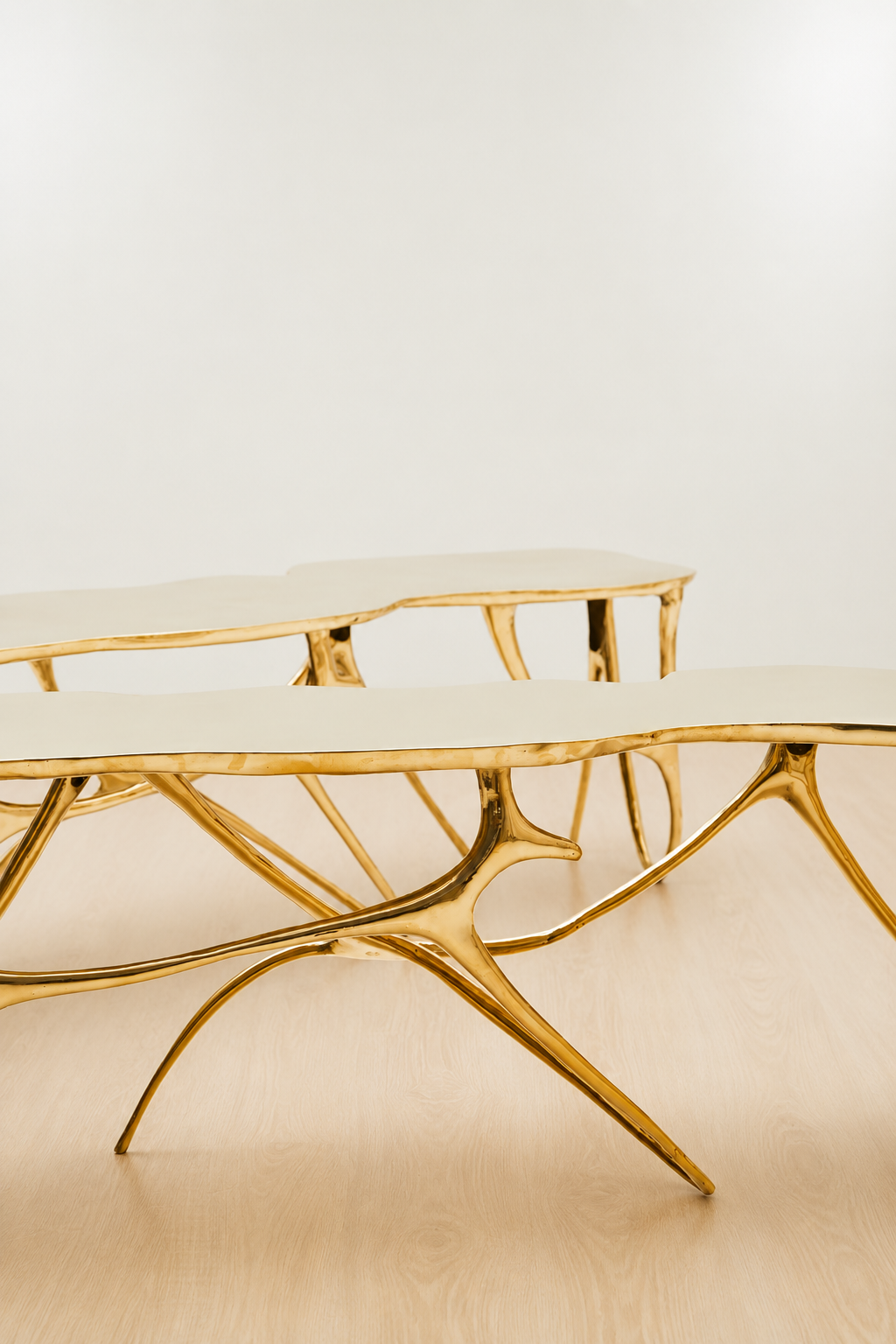 Gold brass luxury handmade furniture bench with modern design, ideal for modern luxury decor, on a white and beige background.