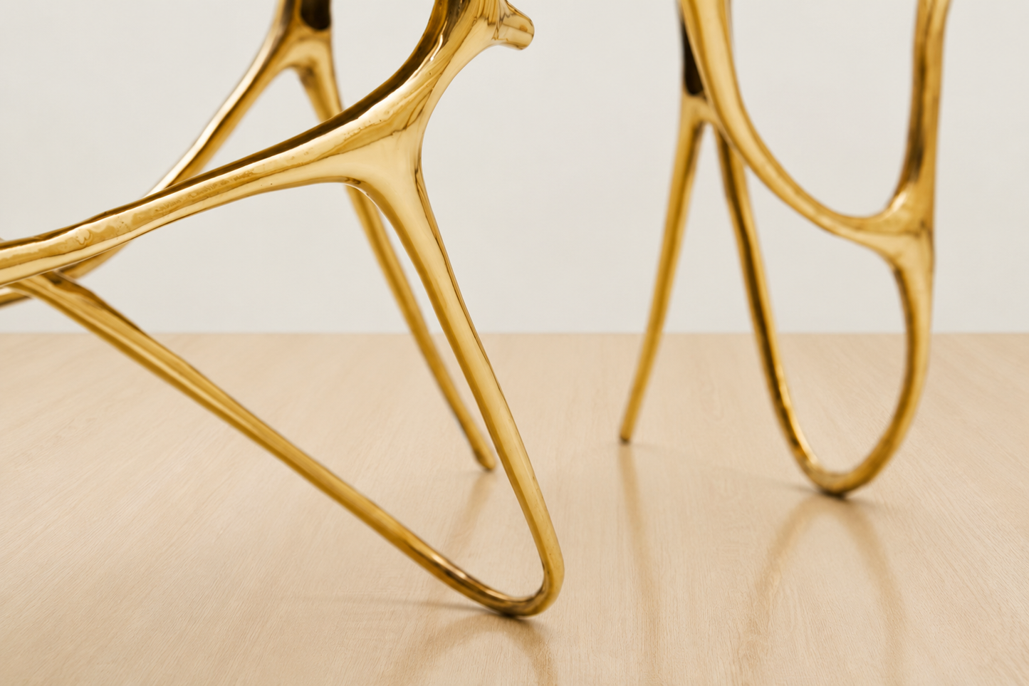 zoom in detail of leg of gold brass bench. 
