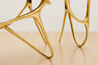 zoom in detail of leg of gold brass bench. 