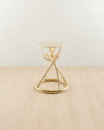 straight view of Gold brass side table with an hourglass design.