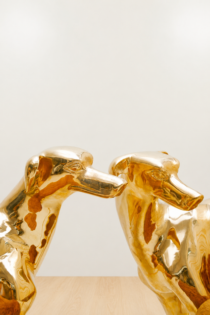Two gold brass dog-shaped chairs. zoomed in