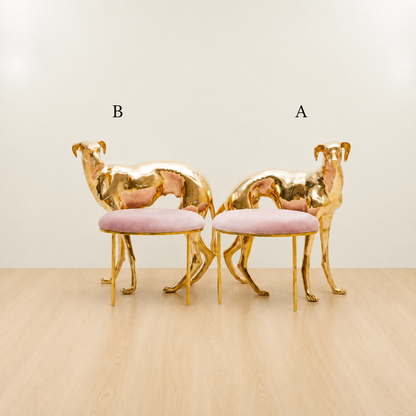 Two brass gold dog chairs with pink cushions on a beige floor and light beige wall.