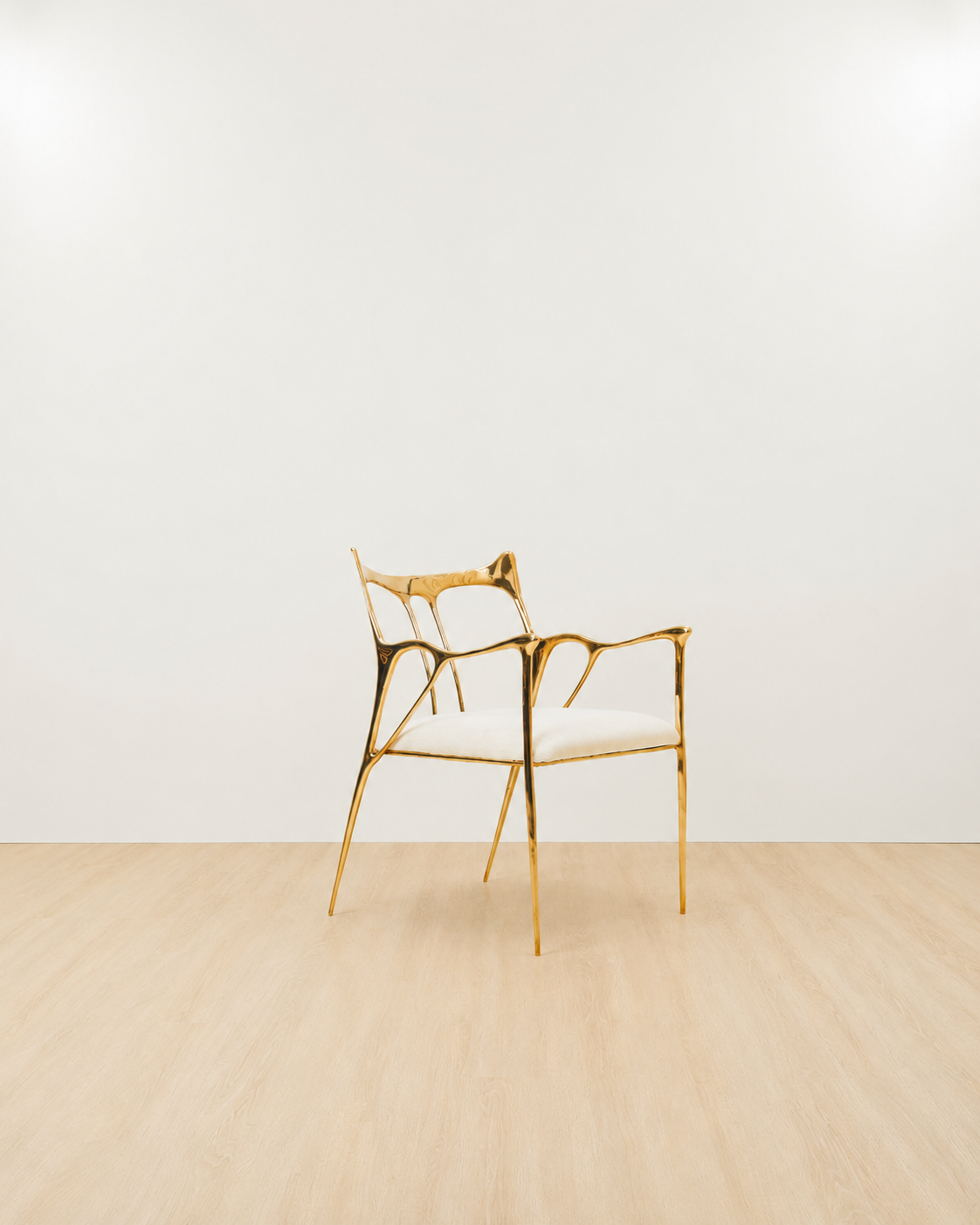 Luxury handmade brass chair with gold finish and white cushion on white background. 