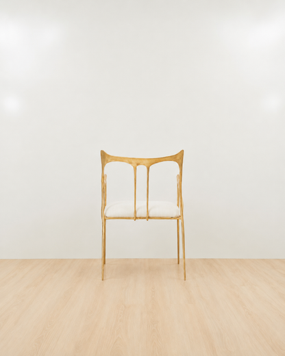 back of a Luxury handmade brass chair with gold finishing and white cushion on a white background. 