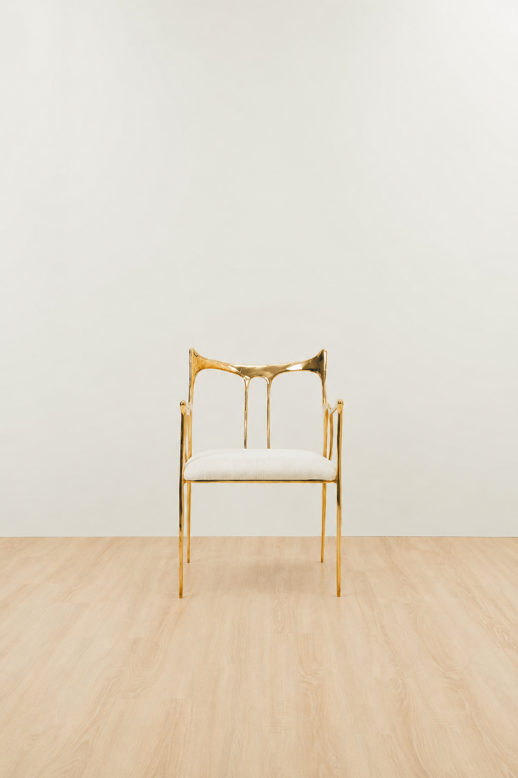 Luxury handmade brass chair with white cushion and gold finish on a plain background