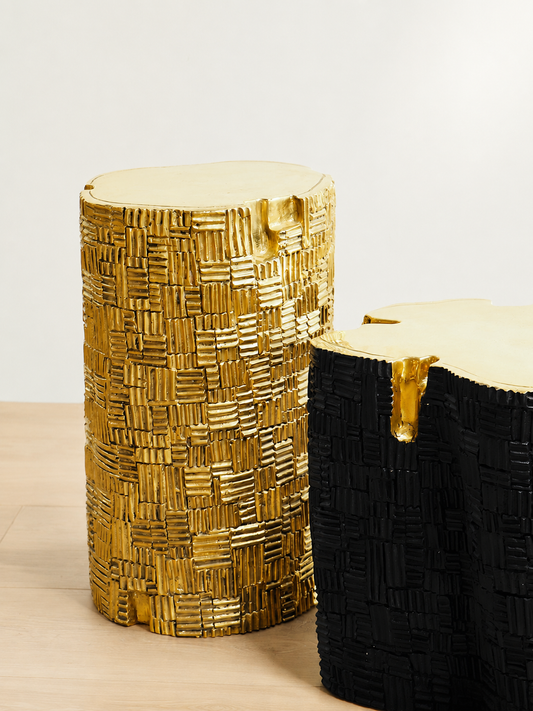 Gold brass and black brass side tables with textured bases and organic shaped tops