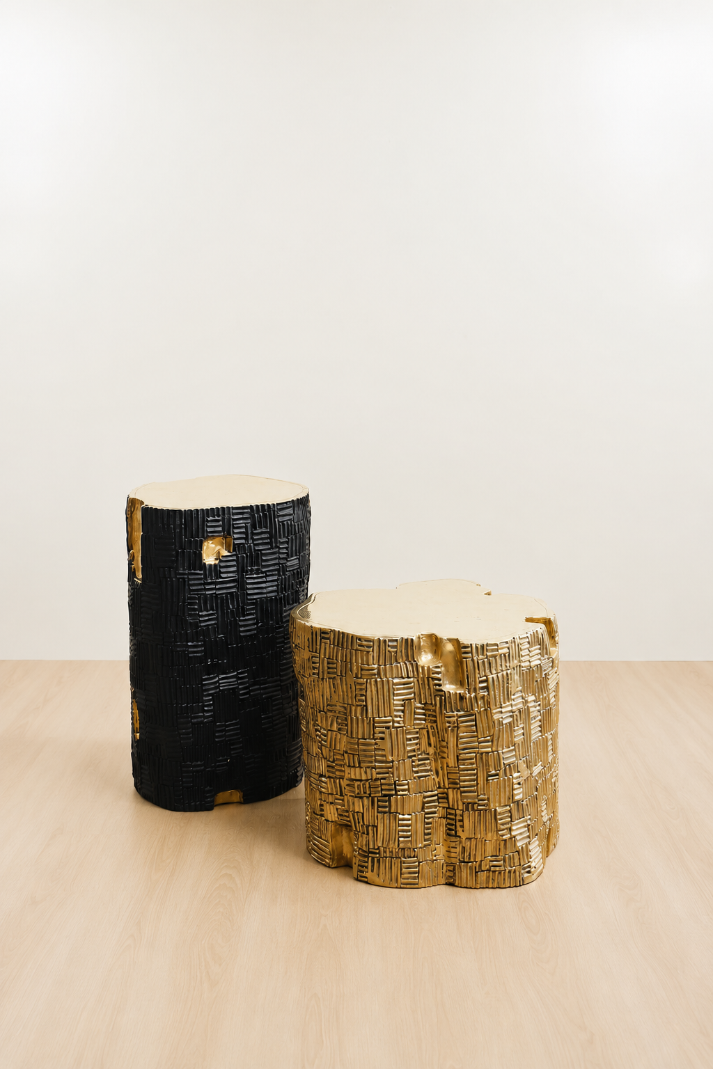 Gold brass and black brass side tables with textured bases and organic shaped tops