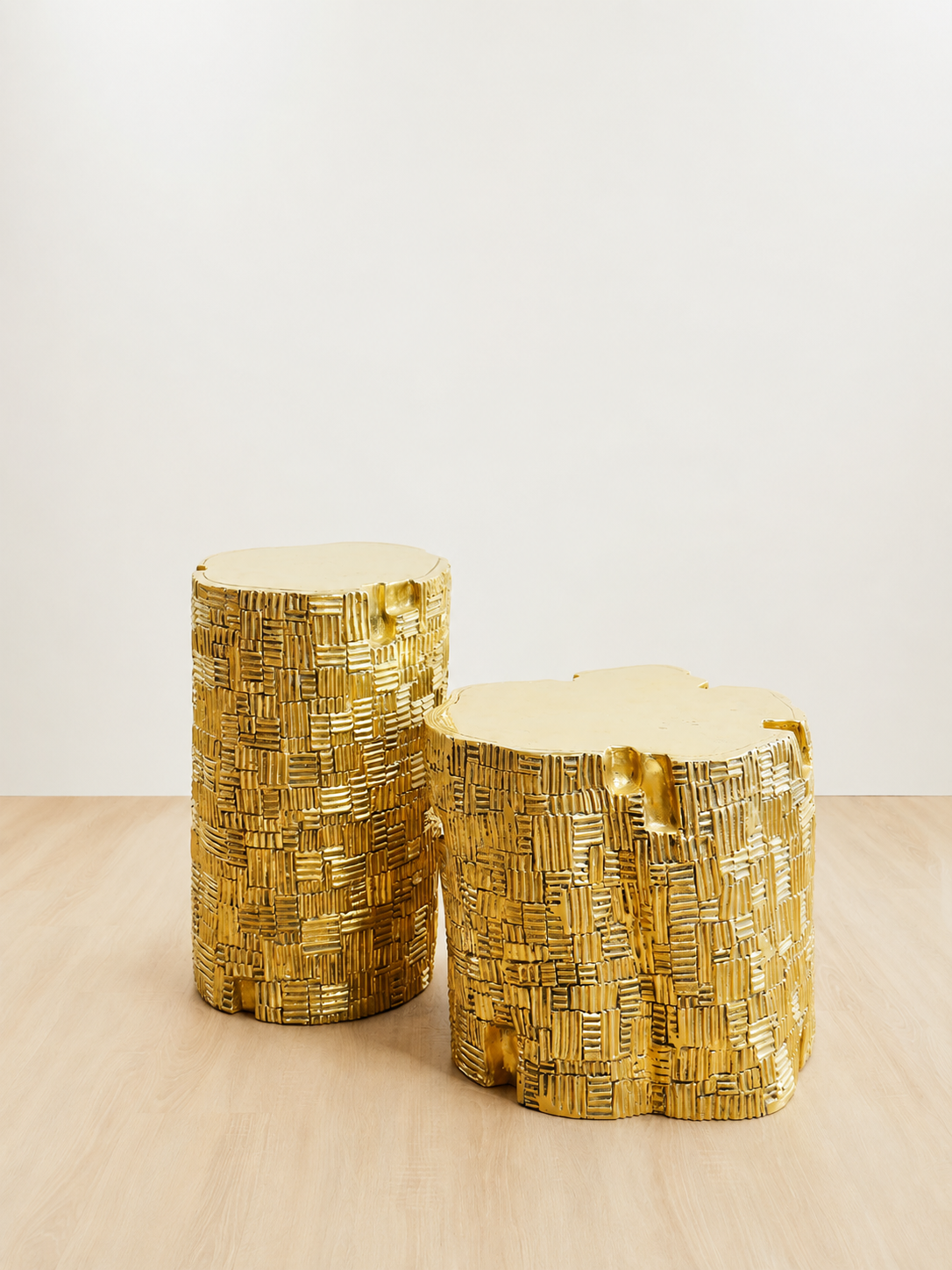 Gold brass side tables in different sizes with textured bases and organic shaped tops
