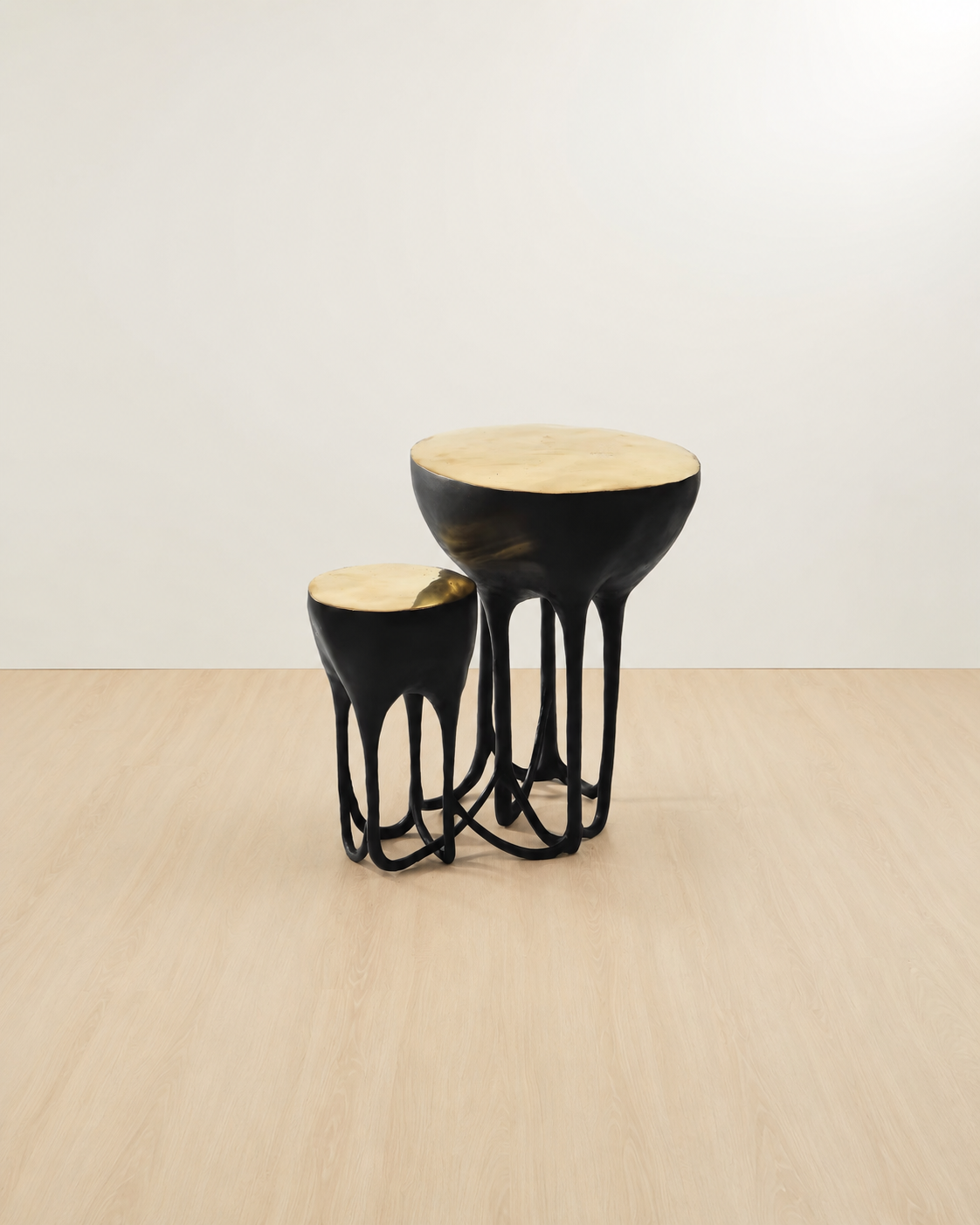 a black side table with gold top on a 