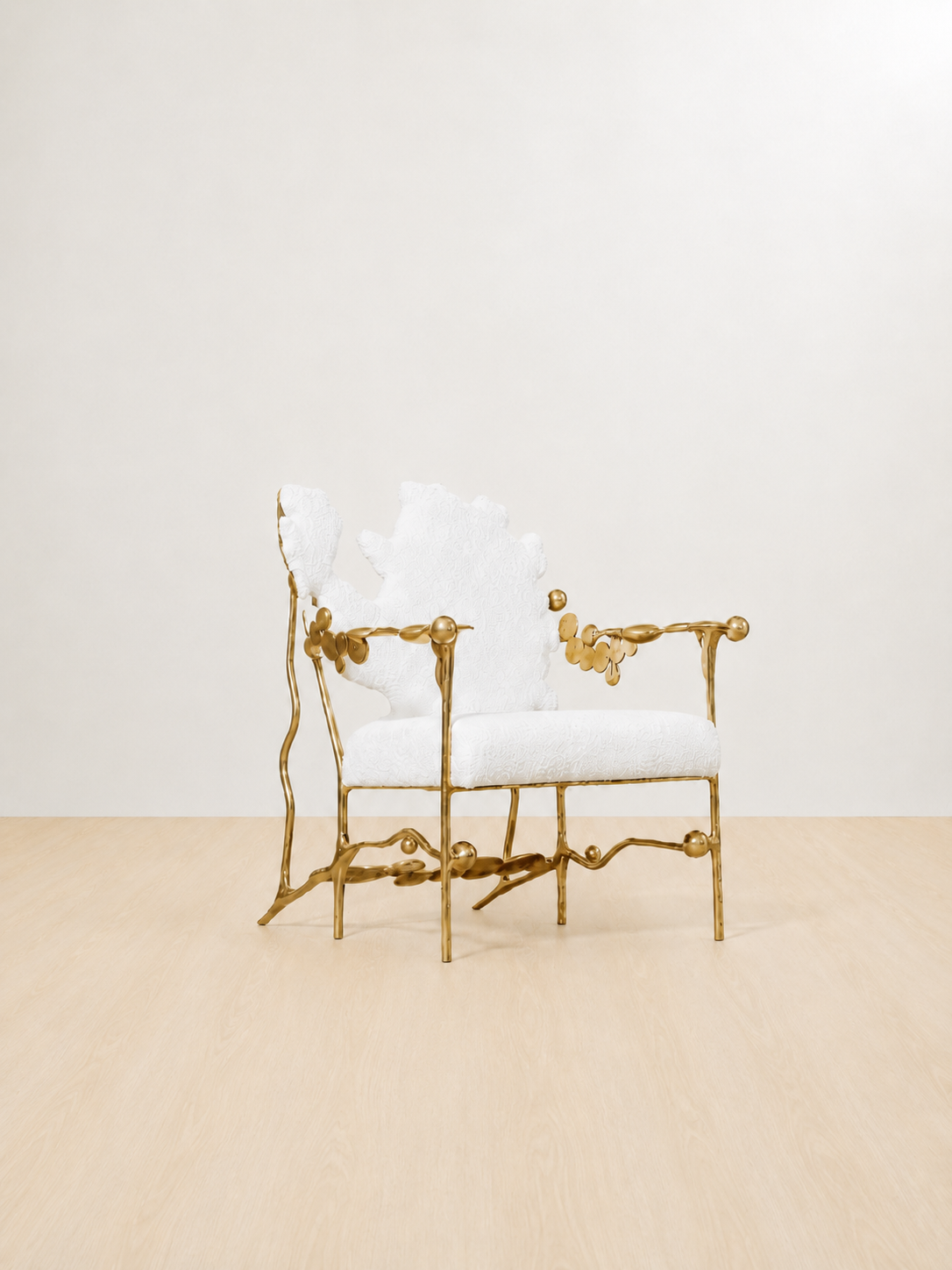 gold brass polished chair with white cushion on a beige floor and light beige wall. side view.