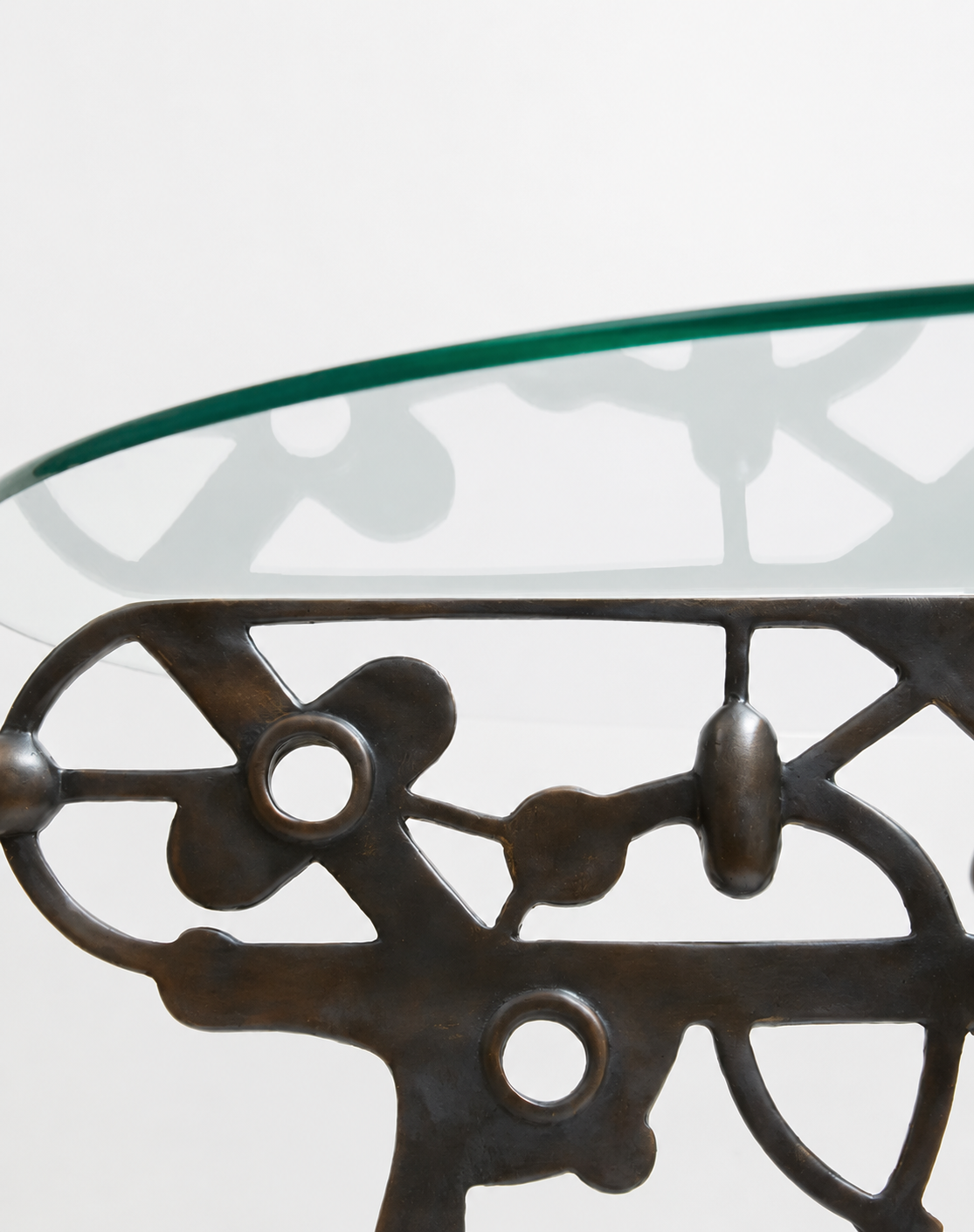 Small round table with glass table top and black brass base 