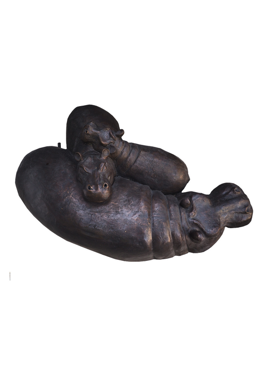 Bronze sculpture of a family of hippos resting their heads on top of each other. 