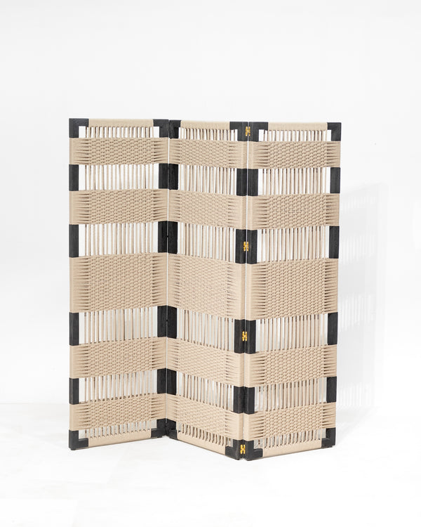A folding screen made of woven beige wicker or rattan with black corner and hinge accents, photographed on a clean white studio background.