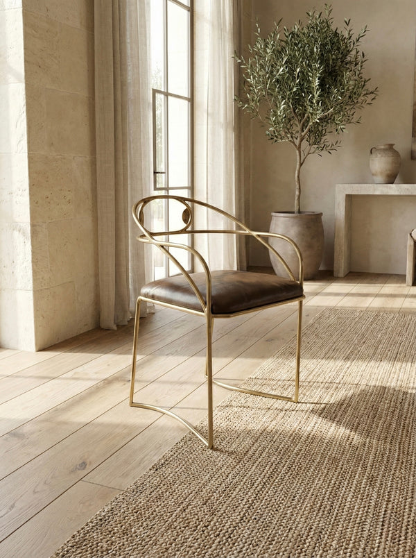 Custom brass chair with gold finished frame and brown leather seat.