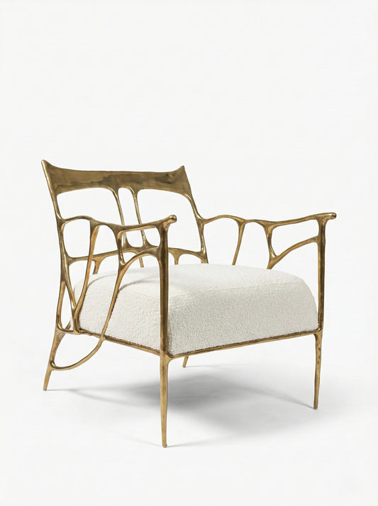 Gold brass armchair with white cushion on a white background