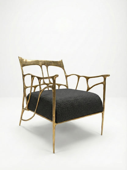 modern brass chair with gold frame and black cushion