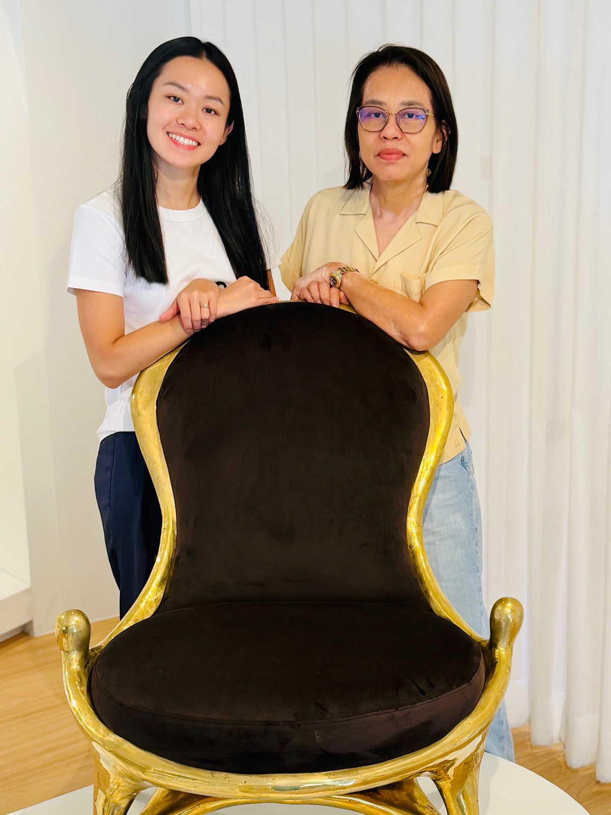 Kanlaya and Saranya Co-founders of Chantr behind a black and gold chair.