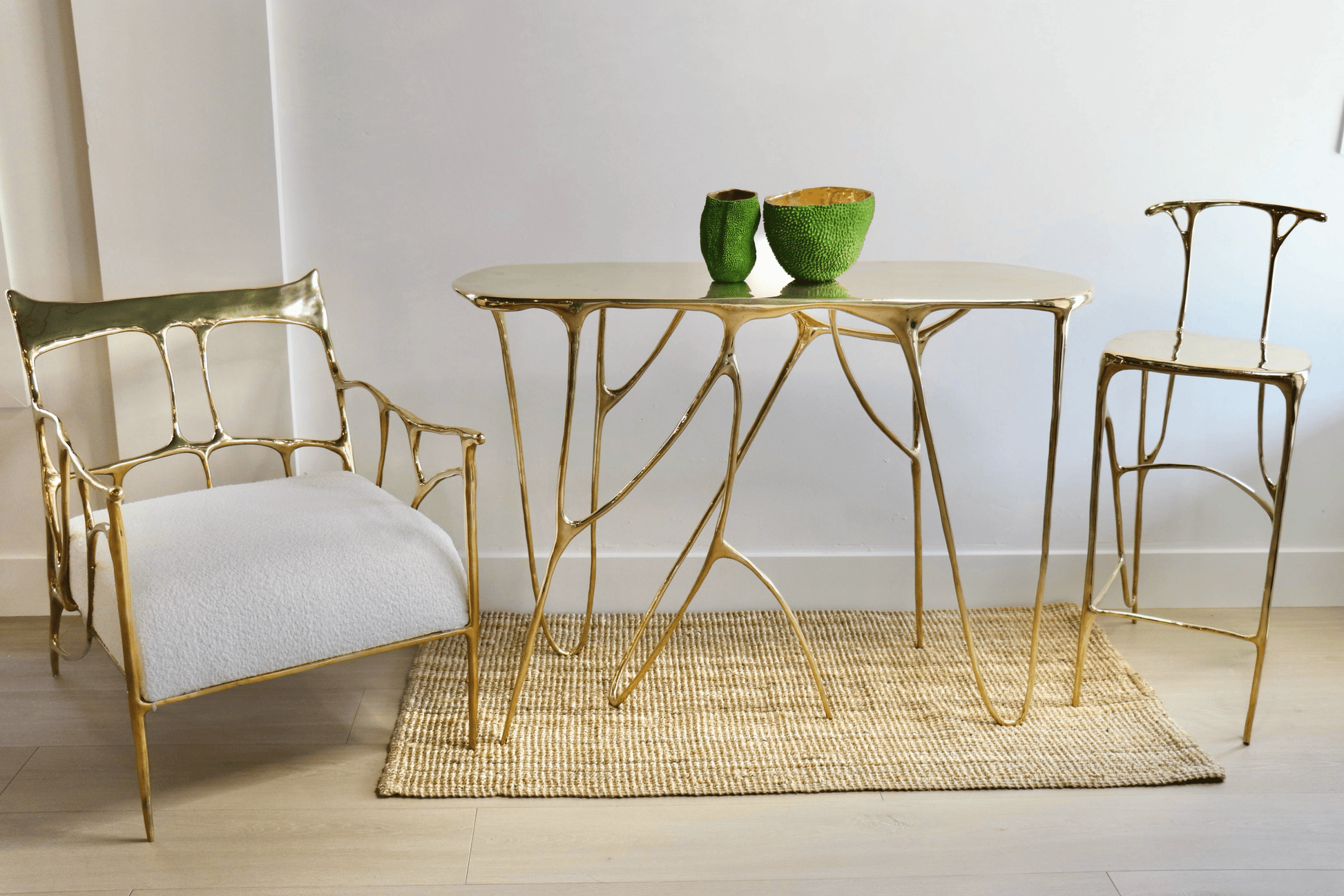 Gold leaf table and chairs with white cushion on a light wooden floor. Luxury handmade furniture