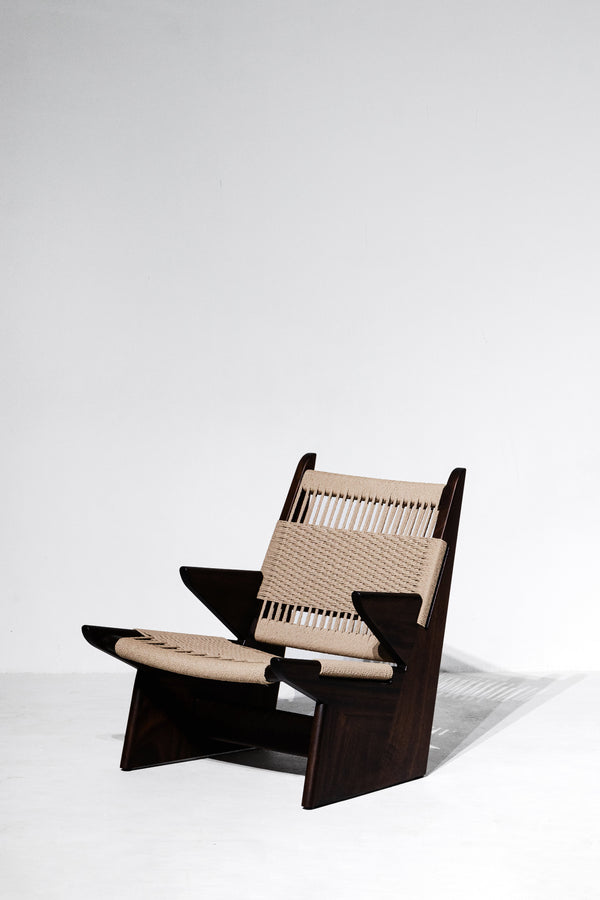 Modern chair with woven seat and backrest on a white background